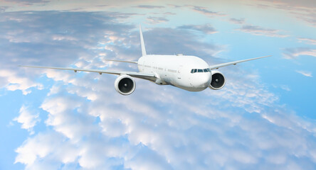 White passenger airplane flying in the sky amazing clouds in the background - Travel by air transport