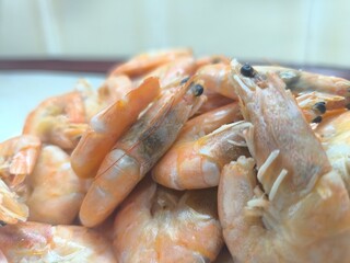 fried shrimps on a white plate on a white wooden table