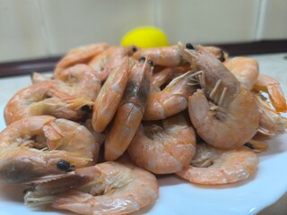 fried shrimps on a white plate on a white wooden table