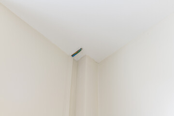 Fototapeta premium Close up detail of motion sensor during house renovation. Modern home construction focuses on clean lines and security for feeling of safety and peace of mind