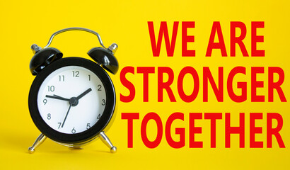 We are stronger together symbol. Beautiful yellow background with alarm clock with words We are stronger together. Business and We are stronger together concept. Copy space.