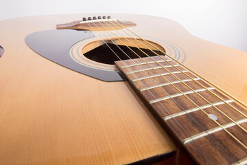 dreadnought six-string guitar made of light wood on a white background. an isolated object. close-up. with a place for the text.