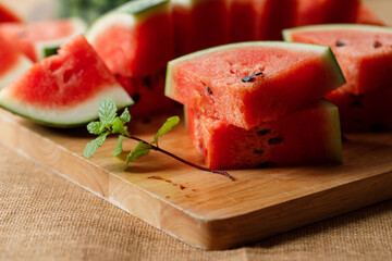 Slices of fresh watermelon on rustic wooden background.