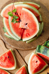 Slices of fresh watermelon on rustic wooden background.