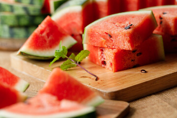 Slices of fresh watermelon on rustic wooden background.