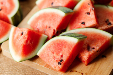 Slices of fresh watermelon on rustic wooden background.