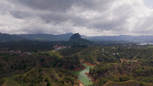 Aerial Drone Shot Approaching Iconic El Penon de Guatape Inselberg Rock, Antioquia, Colombia, South America.