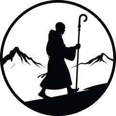 Monk hiking with staff in the mountains silhouette