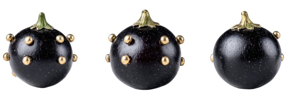 Three dark purple/black round fruits with small gold dots