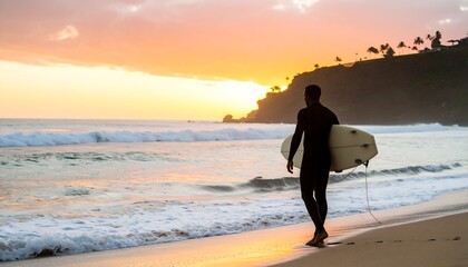 Surfer silhouetted at sunset, ocean waves