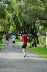 Fresh green lawns in the park. Blur nature bokeh green park trees in morning.