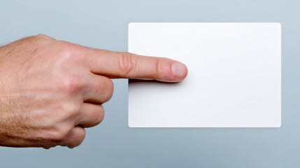 Fototapeta premium Hand Holding Blank Card Against Light Gray Background
