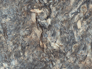 Natural rough stone background, dark grey-colored marble texture with volcanic rock pattern, designed for outdoor parking tiles.