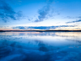 sunset on the icy lake in winter