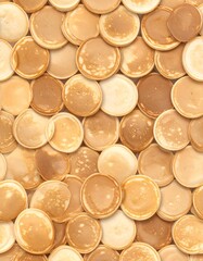 A close-up view of many golden-brown pancakes, perfectly layered and arranged in a seamless pattern, showcasing a variety of shades and textures.