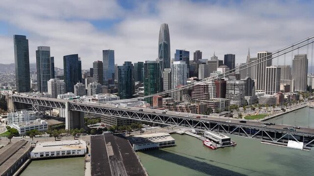 An aerial view of San Francisco reveals a vibrant cityscape of rolling hills, diverse architecture, and iconic landmarks nestled along the edge of the Pacific coast.