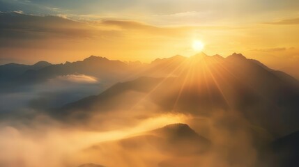 Golden hour mountain range landscape shrouded in soft misty clouds
