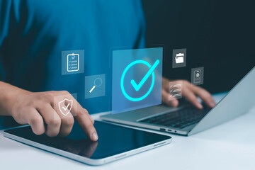Digital approval and task management concept with glowing check mark icon tablet and laptop, symbolizing verification, business success, workflow efficiency, document validation, quality assurance.