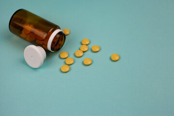 Medical pills in a jar on a blue background. View from above