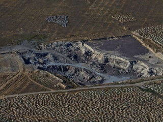 An industrial quarry in a semi-desert area. Mining of various rocks. The view from the drone.