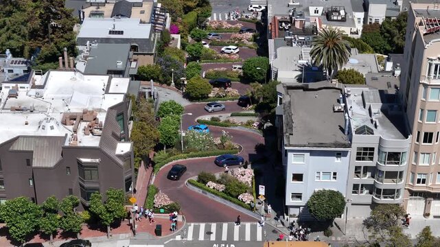 Aerial view of Lombard Street&rsquo;s famous crooked block in San Francisco, showcasing its eight sharp hairpin turns winding steeply through Russian Hill, a top tourist attraction.