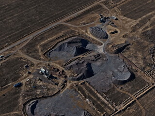An industrial quarry in a semi-desert area. Mining of various rocks. The view from the drone.