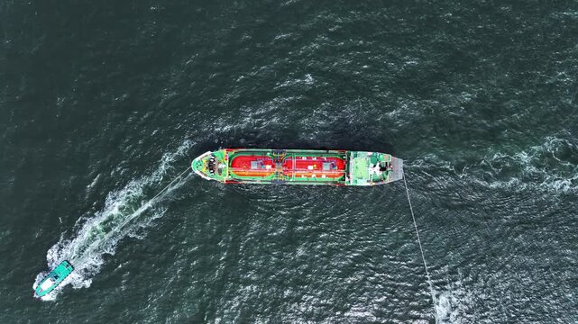 Aerial view LPG tanker ship at sea, Red LPG tanker ship top view, Logistic and maritime transportation of petroleum, Modern offshore terminal  loading tanker ship.