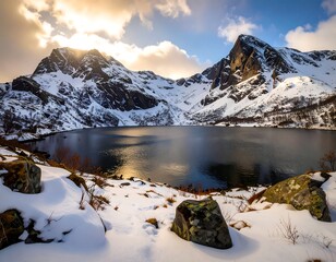 Serene snow-capped mountains reflecting in a still lake at sunset
