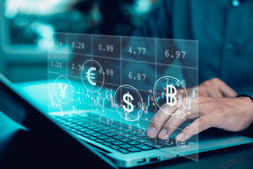 Businessman using laptop with global currency symbols and trading chart, representing forex market, international finance, and digital investment technology.
