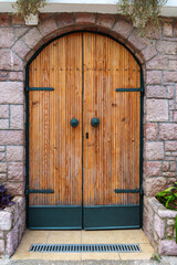 door made of wooden planks with handles, varnished wood in light brown or yellow color as an abstract background