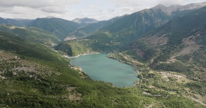 Aerial view of Lago di San Sebastiano nestled amongst the lush green mountains, with small villages visible along the shore, Frattura Vecchia, Abruzzo, Italy.