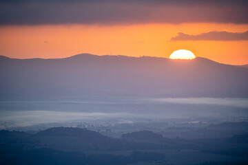 Sunrise Over Distant Hills