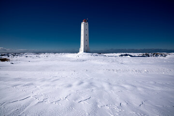 Lighthouse on Snowy Landscape