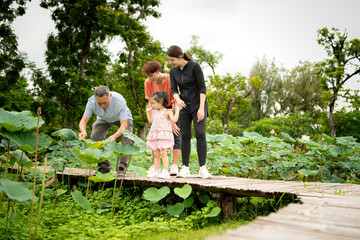Asian family stroll through a large flower garden