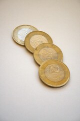 Multiple Hungarian 200 forint coins arranged in a row on white background, close-up with copy space.