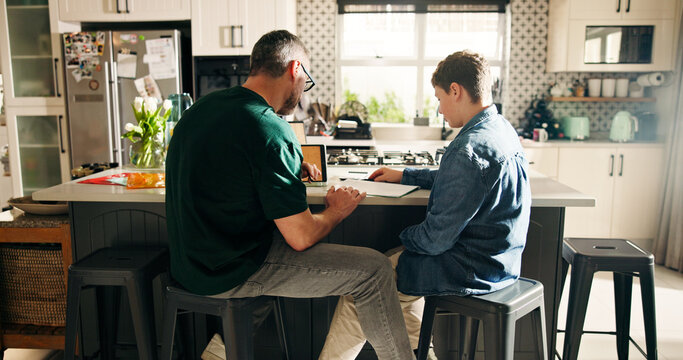 Home, dad and child with notebook, education and help with math exam, growth or development for boy. Learning, student and man with kid in kitchen, family and preparing for test, knowledge and advice