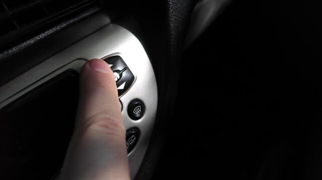 analog car buttons. Man finger pressing play button on vintage tape player. close up finger pressing off button on car climate control panel to disable ac while illuminated recirculation