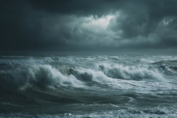 Restless sea surges beneath dark sky as storm clouds gather on the horizon and waves crash against the shore in a powerful display of nature's fury