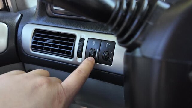 analog car buttons. Man finger pressing play button on vintage tape player. close up finger pressing off button on car climate control panel to disable ac while illuminated recirculation
