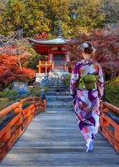 Japanese Woman in Traditional Kimono Dress at Daigoji Temple with beautiful foliage in autumn in Kyoto, Japan