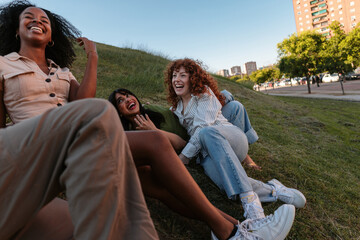 Friends laughing together enjoying outdoor gathering in a park