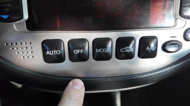 analog car buttons. Man finger pressing play button on vintage tape player. close up finger pressing off button on car climate control panel to disable ac while illuminated recirculation