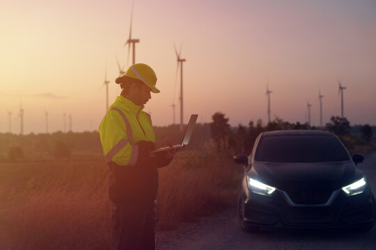 Engineer technician working at wind turbine power plant in the early morning Renewable energy solutions for climate change, clean energy