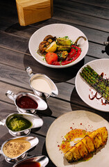 Enjoy grilled veggies and sauces at a modern dining spot