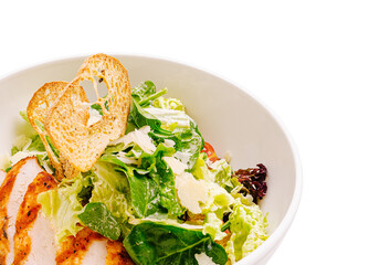 Fresh salad with grilled chicken and toasted bread on a white background