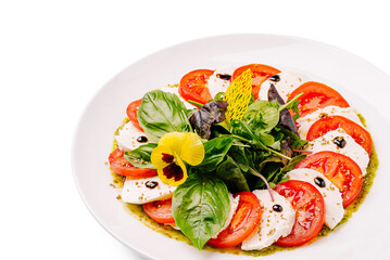 Fresh mozzarella and tomato salad with basil and herb pesto drizzle
