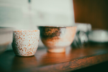 Ceramic pots on a wooden shelf as a decoration item in a row