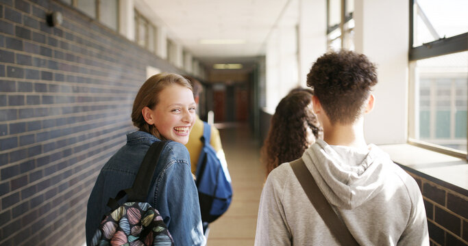 Happy people, students and walking with back in school hallway for class schedule on campus. Portrait, friends or teenager with group, bag or smile for education, learning or development in corridor - Powered by Adobe