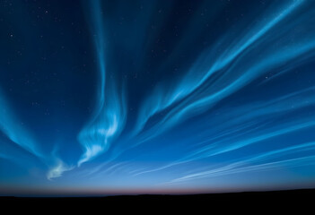 Stunning noctilucent clouds glow with an ethereal blue light, forming wavy patterns across the dark twilight sky with distant stars.