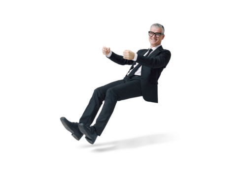 Happy corporate businessman driving an invisible car